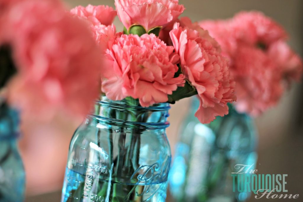 Pink carnations in blue mason jars