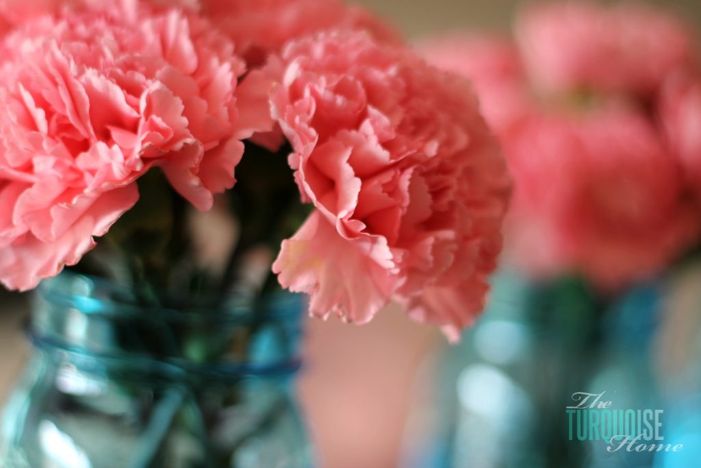 Pink carnations in blue mason jars