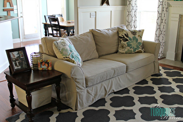 Gorgeous Living Room Makeover with beautiful DIY board and batten, Pottery Barn sofa, stenciled curtains, warm wood and pops of turquoise!