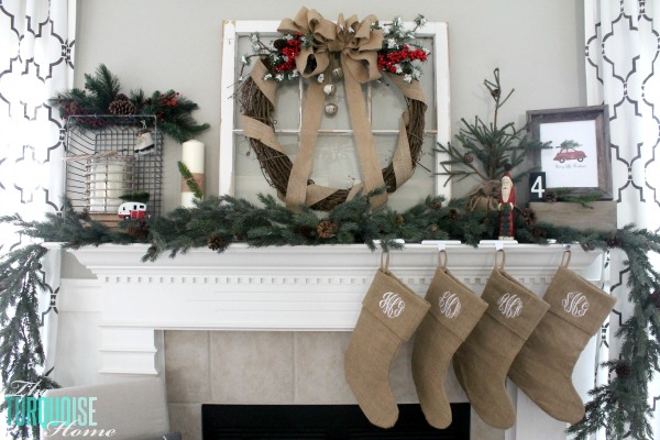 burlap ribbon bow in a grapevine wreath adorned with large Christmas bells