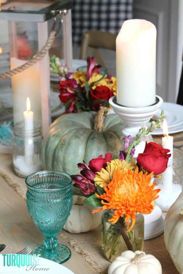 Gorgeous! This pretty, colorful fall or Thanksgiving tablescape is just beautiful with pops of turquoise, orange and red! And those beautiful goblets are my fave!