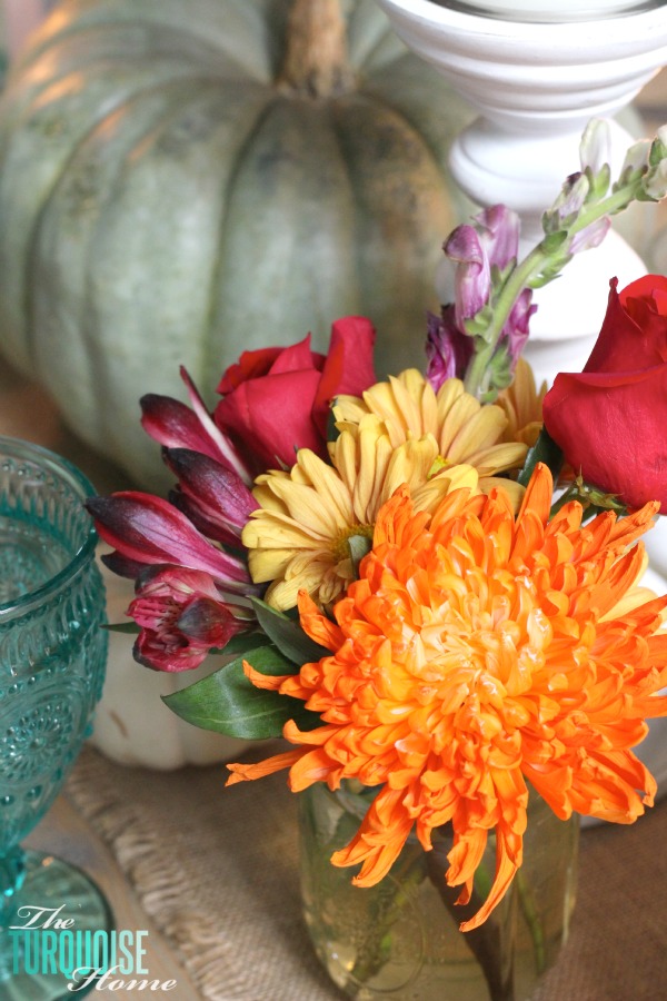 Gorgeous! This pretty, colorful fall or Thanksgiving tablescape is just beautiful with pops of turquoise, orange and red! And those beautiful goblets are my fave!