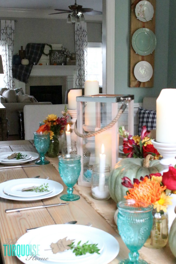 Gorgeous! This pretty, colorful fall or Thanksgiving tablescape is just beautiful with pops of turquoise, orange and red! And those beautiful goblets are my fave!