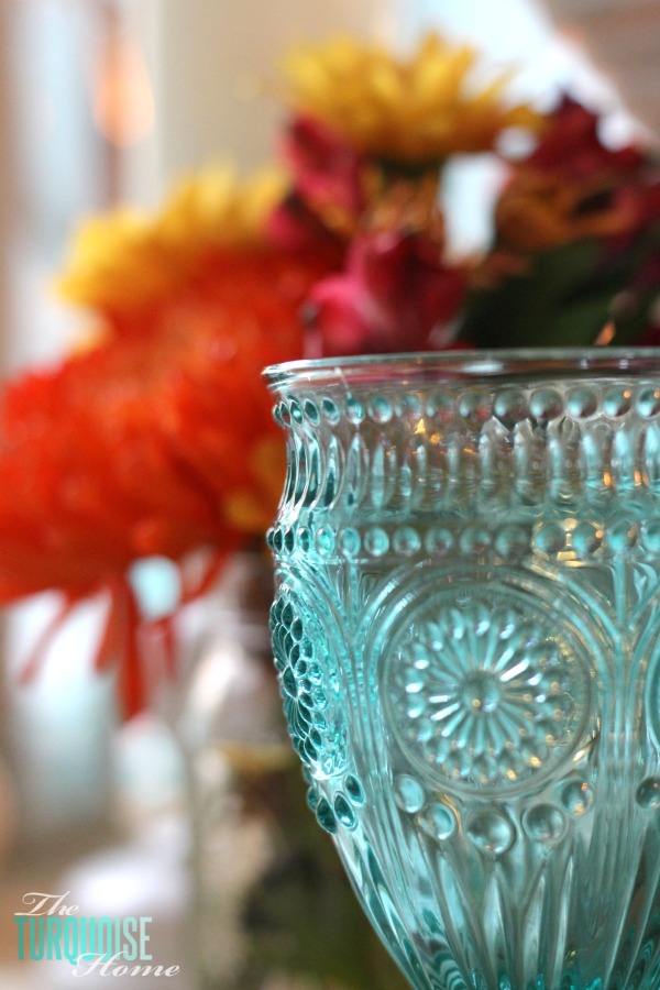 Gorgeous! This pretty, colorful fall or Thanksgiving tablescape is just beautiful with pops of turquoise, orange and red! And those beautiful goblets are my fave!