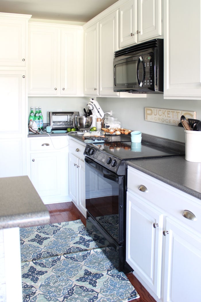 How to Paint Kitchen Cabinets without Fancy Equipment. I didn't even sand the cabinet bases, which saved a ton of time! You'll never guess how we did it!