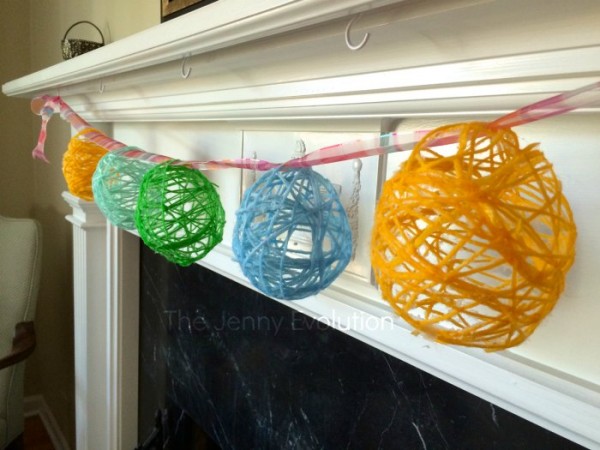 DIY Easter Egg Garland hanging above the fireplace.