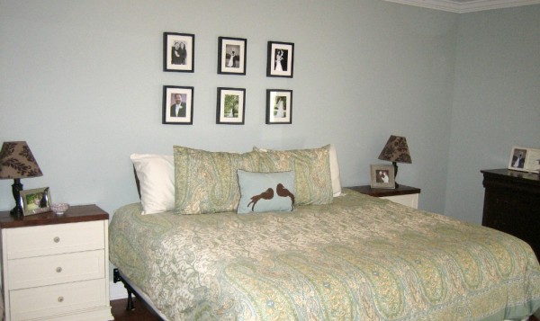 Old master bedroom has tiny little frames on the wall. It needs something much bigger!