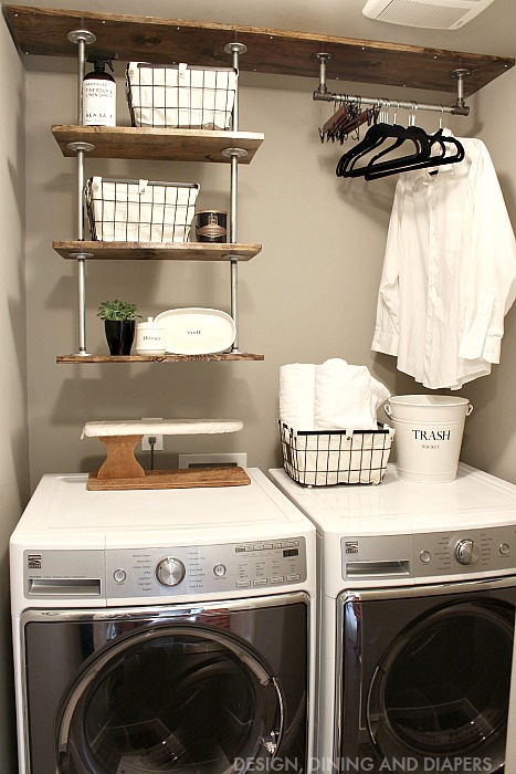 A small laundry room with drop down industrial shelving.