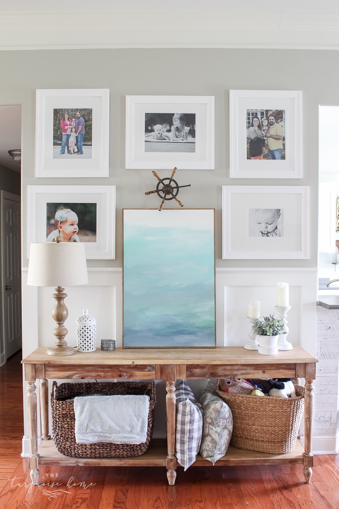 Simple, large photos create a unified photo gallery wall in the living room!