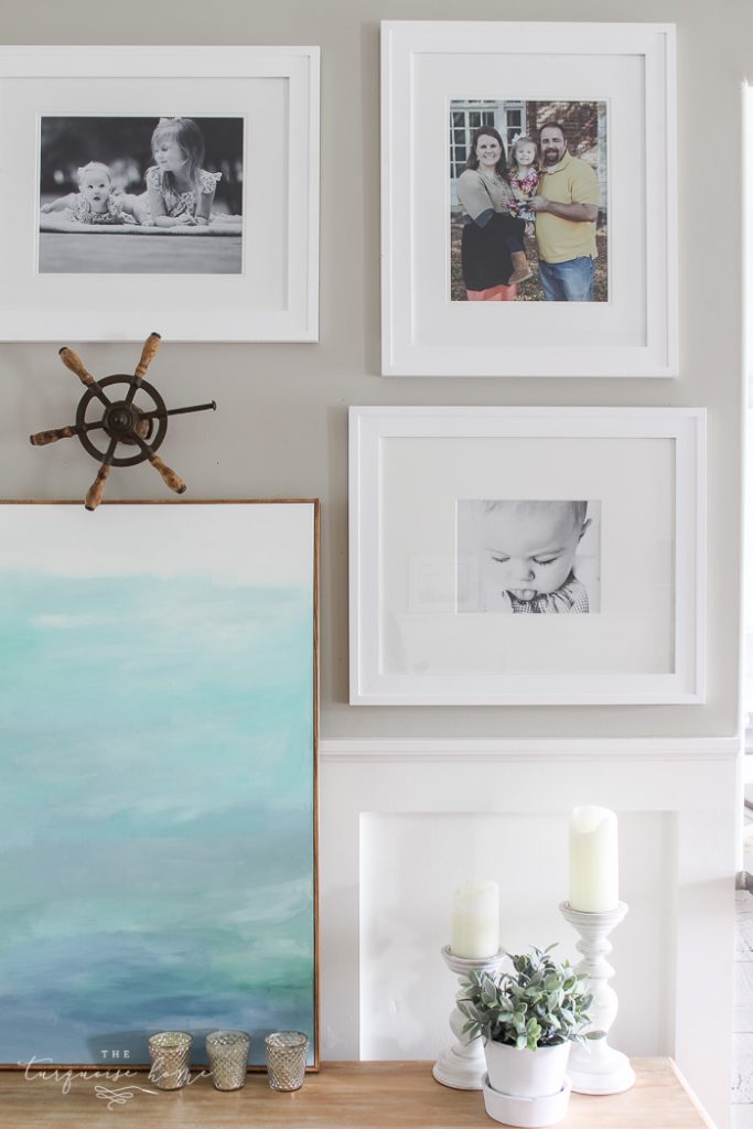 Simple, large photos create a unified photo gallery wall in the living room!