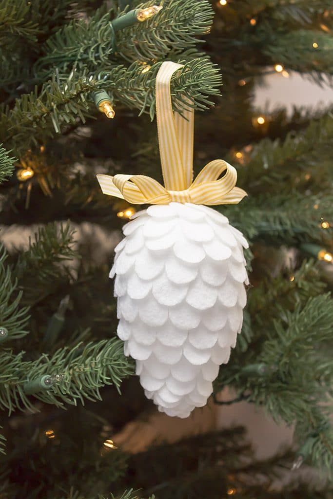 DIY white pinecone hanging on the tree.