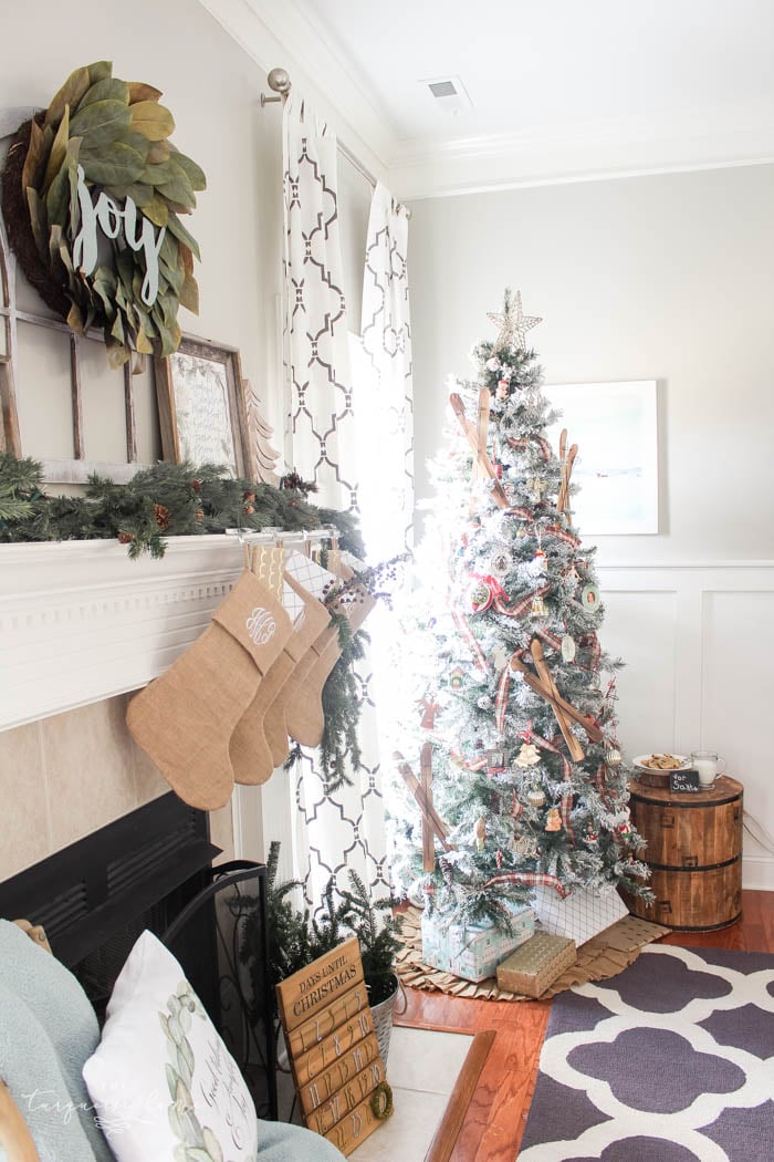 Pretty magnolia wreath Christmas mantel decor brings a rustic feel to the holiday season. Pops of navy and dusty blue are festive, yet unexpected! | Gorgeous Magnolia Wreath Christmas Mantel Decor