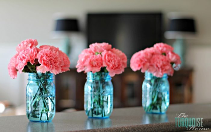 Pretty pink carnations in blue mason jars