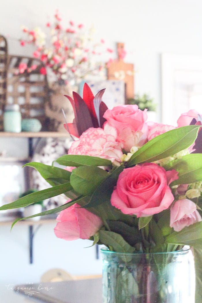 Isn't this just the prettiest pink and turquoise mantel?! Simple Floral Spring Mantel