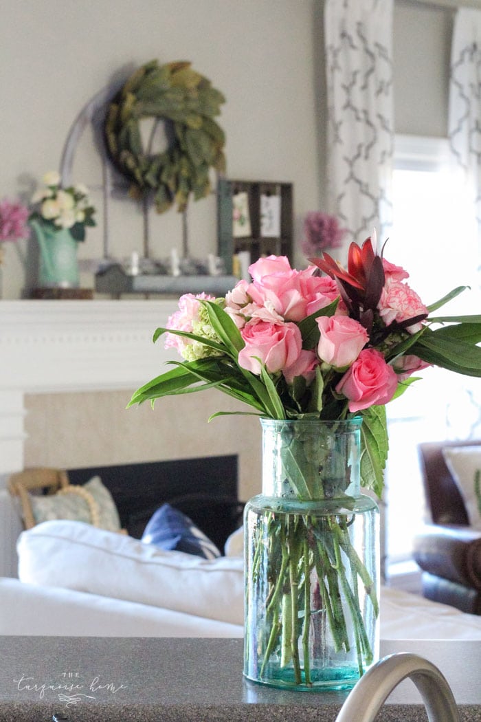 Isn't this just the prettiest pink and turquoise mantel?! Simple Floral Spring Mantel