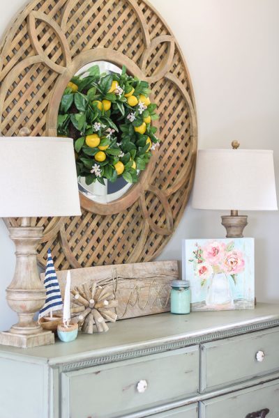 A large round wooden mirror packs a decorative punch in this space!