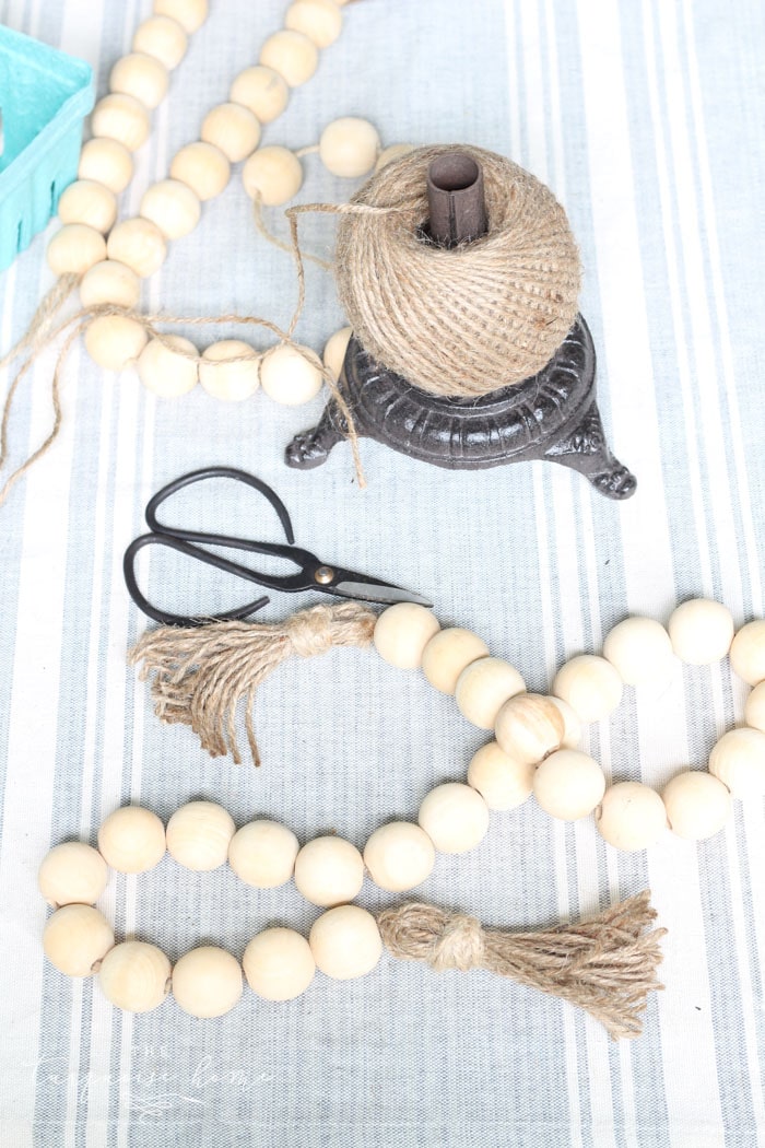 Super cute DIY Wood Bead Garland with Tassels is so easy and fun to make! Cheap, too!!