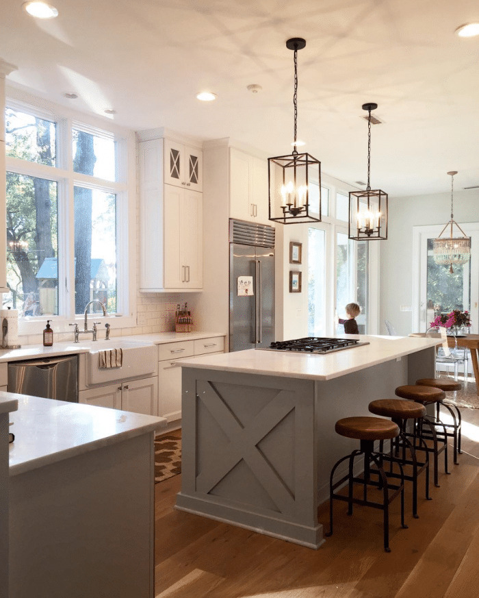 Gorgeous Repose Gray from Sherwin Williams adorns this beautiful kitchen island. Click through for more Colorful Kitchen Island Ideas!