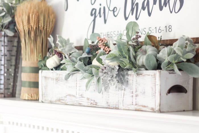 Adorable faux foliage centerpiece made with a wooden box, mason jars and faux stems. LOVE!