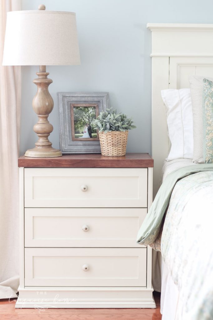 Splurge vs. Save: Ikea Rast Hack Nightstands | farmhouse nightstand | white and wood nightstand with faux lambs ear and wooden turned lamp