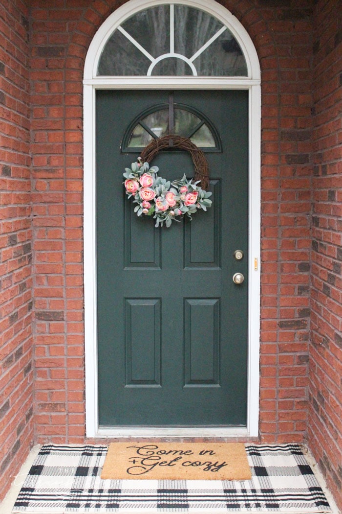 Front door with layered doormats and DIY peonies spring wreath!