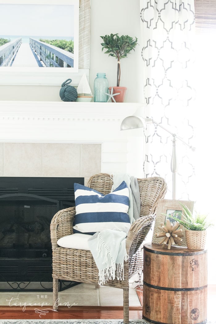 Add a little nautical charm to your living space with these simple coastal summer mantel decor ideas. Featuring DIY beach canvas art, blue & white starfish, textured sailor's knot and cheerfully striped sail boats, this mantel looks great for the seasonally inspired.