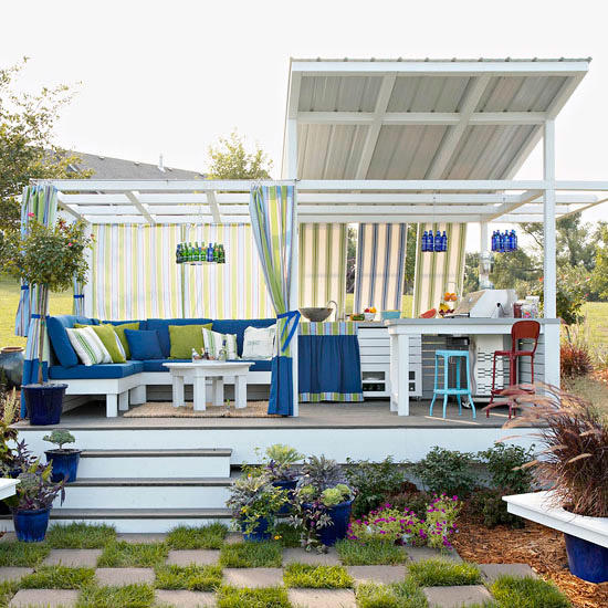 This space boasts an outdoor kitchen, sitting area, outdoor checkerboard, and colorful finishing touches, including outdoor fabrics that add color and style.