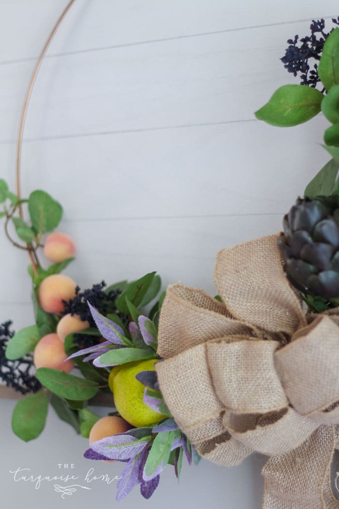 Add a burlap bow to the center of the hoop wreath to cover up all of the stems and floral wire in the middle!