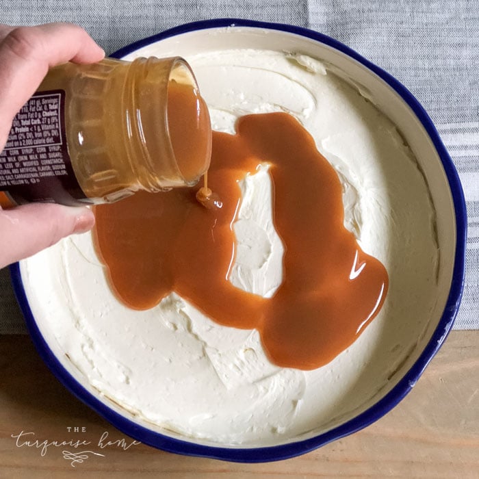 Pour the caramel sauce over the cream cheese spread. | Cream Cheese Caramel Apple Dip Recipe