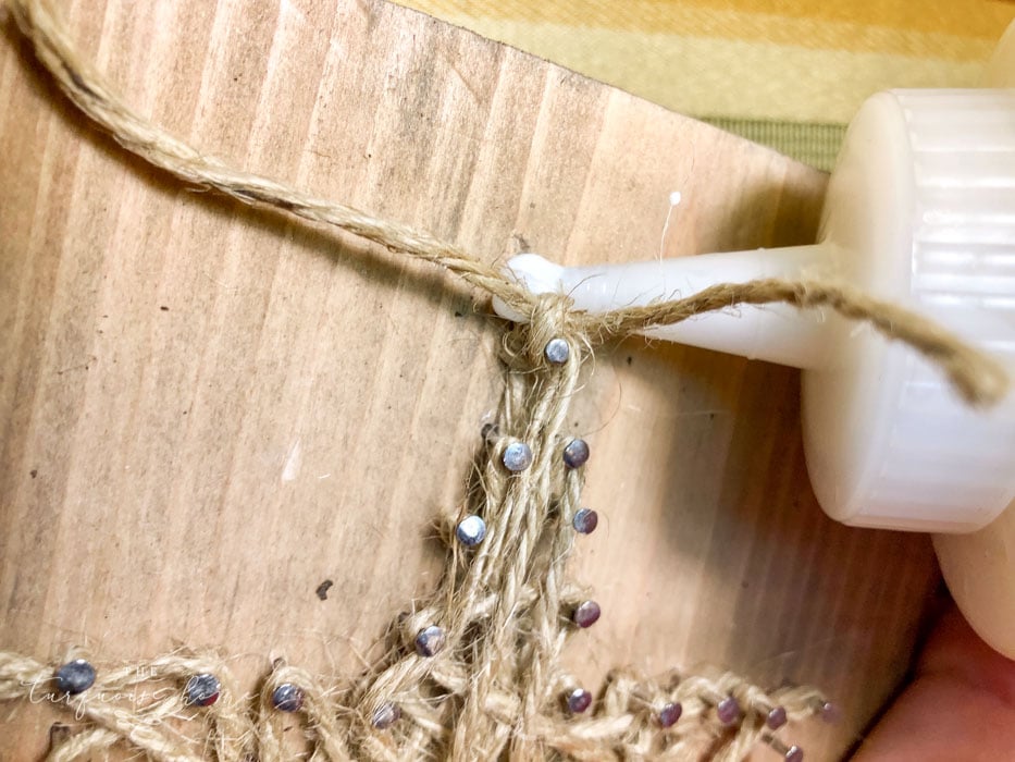gluing the last string on nail art