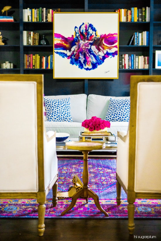 Art layered on a bookshelf - How to Decorate a Bookshelf