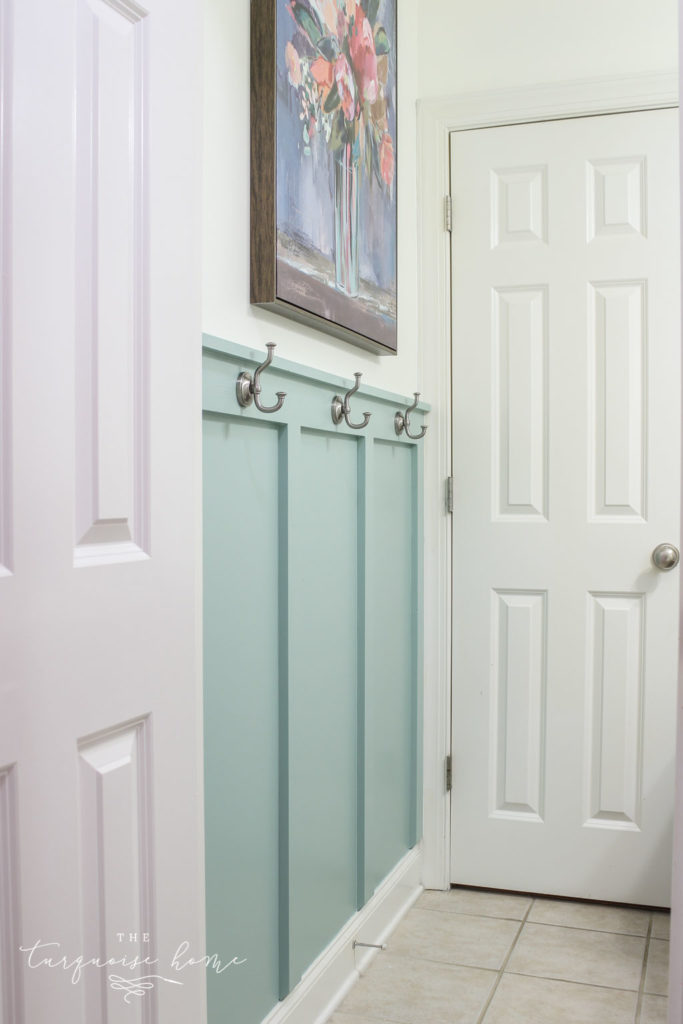 DIY Board and Batten Treatment in the bathroom with hooks | Wythe Blue by Benjamin Moore