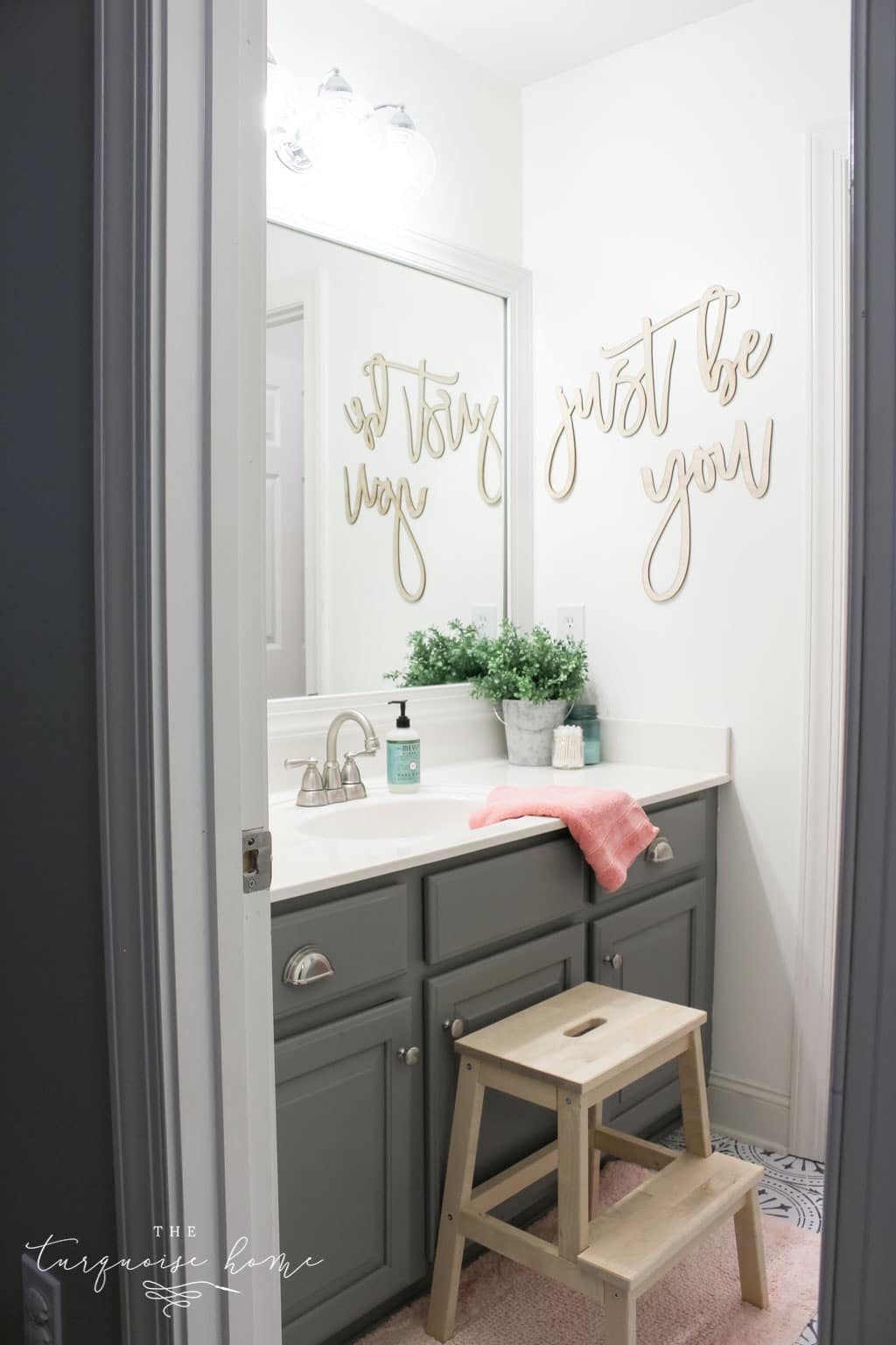 How to Create Big Style in a Small Bathroom | The Girls' Bathroom Refresh Reveal | Wooden Step Stool | Pink Towels | Gray painted cabinets