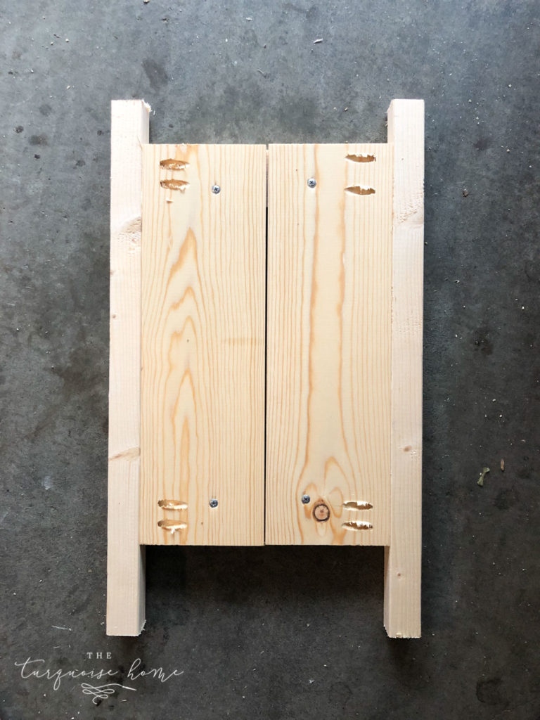 DIY Wood Planter -->> Attach two of the feet to the sides of one panel with the pocket hole screws. 