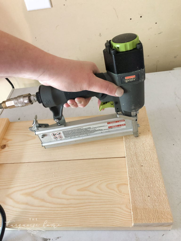 DIY Wood Planter -->> Add the 11" boards to the top of 2 side panels and nail them in with the brad nailer