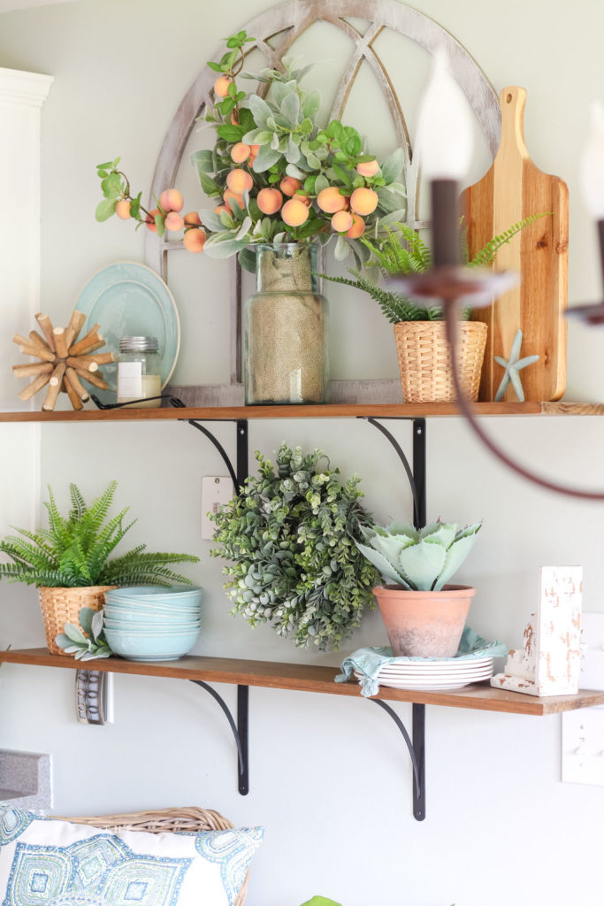 Open Kitchen Shelves Decorated for Summer - peach stems, turquoise dishes and lots of greenery