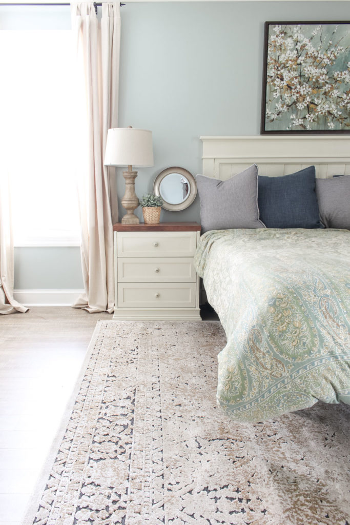 Gorgeous Ivory and Beige Antique-style Rug in a Farmhouse Master Bedroom. What size rug to buy for a king bed?