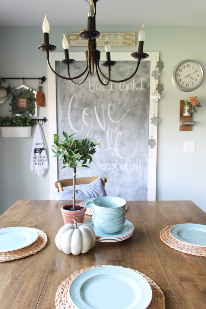 Eat-in kitchen area with a few simple fall touches, like a pumpkin on the table and a bay leaf topiary. #falldecor #homedecor #fallhometour
