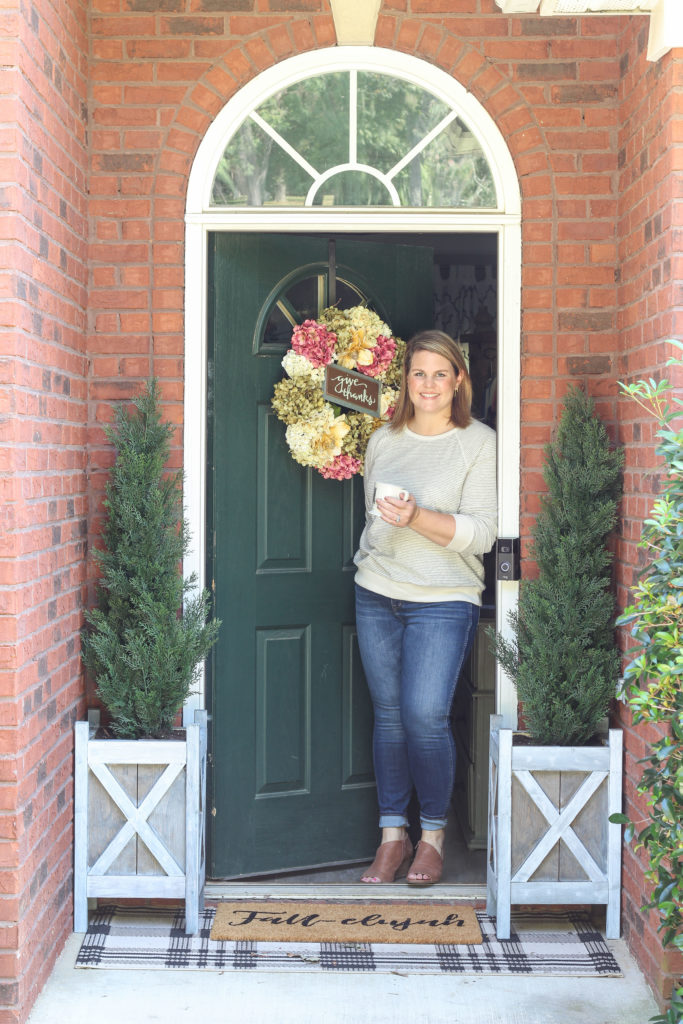 Cozy fall home tour with simple decor ideas for anyone on any budget! Hydrangea wreath, tall evergreen topiaries, fall-elujah doormat.  