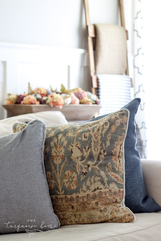 Neutral fall decor with some small pops of jewel tones - bring a cozy, yet fun vibe to this fall living room decor. 