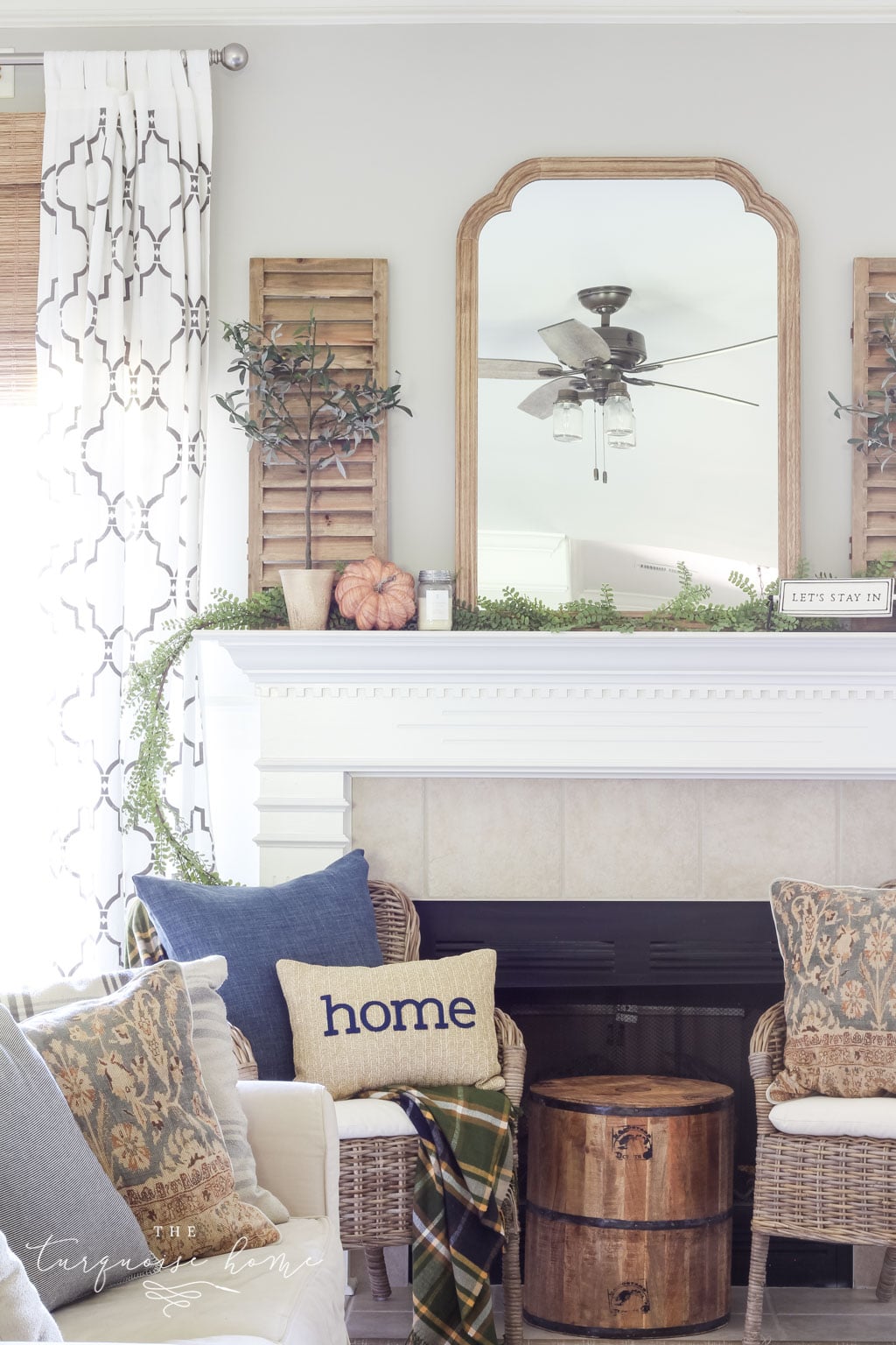 Beautiful neutral fall mantel with blues and browns and beautiful fall greenery. See all of the details and sources here: TheTurquoiseHome.com