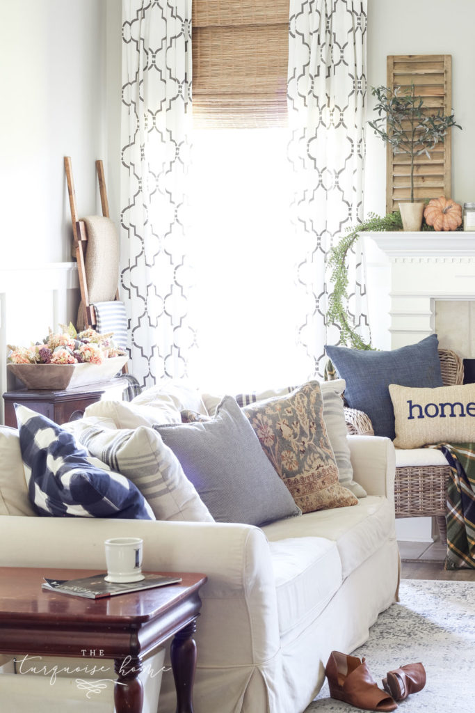 Fall Living Room Decor with mantel with wood shutter decor and browns and blues. 