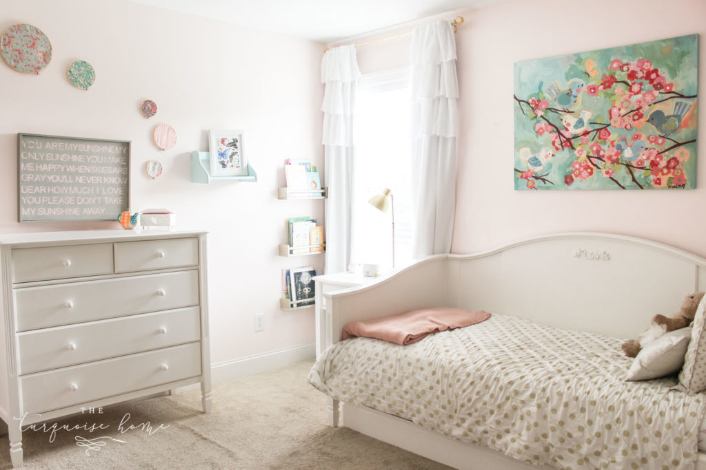 gold, pink and turquoise girls bedroom decor with hoop art and white daybed with white dresser.