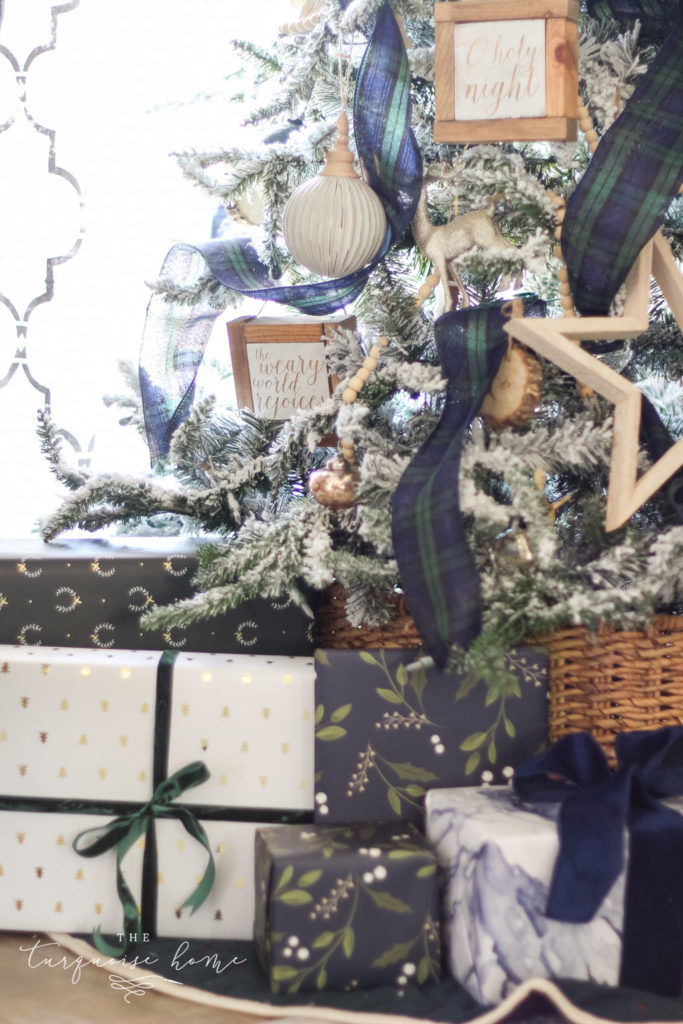 Beautiful blues and greens in the wrapping paper coordinate perfectly with the Christmas decor! Flocked Christmas Tree with Navy and Green plaid ribbon
