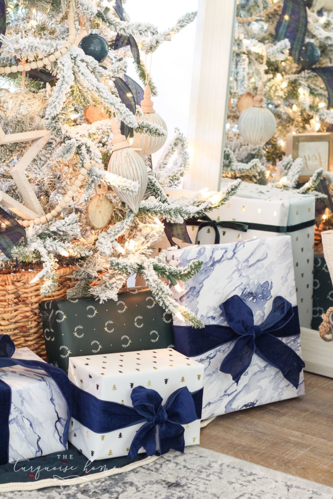 Beautiful blues and greens in the wrapping paper coordinate perfectly with the Christmas decor! Flocked Christmas Tree with Navy and Green plaid ribbon