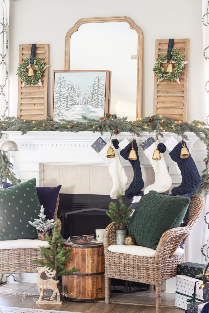 navy and white knit stockings with Christmas bells lining a white mantel