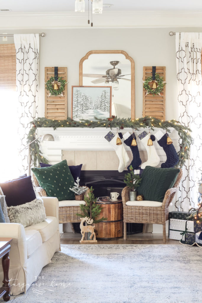 Green and Navy Simple Christmas Mantel - pretty gold bells, cable knit stockings and beautiful velvet pillows