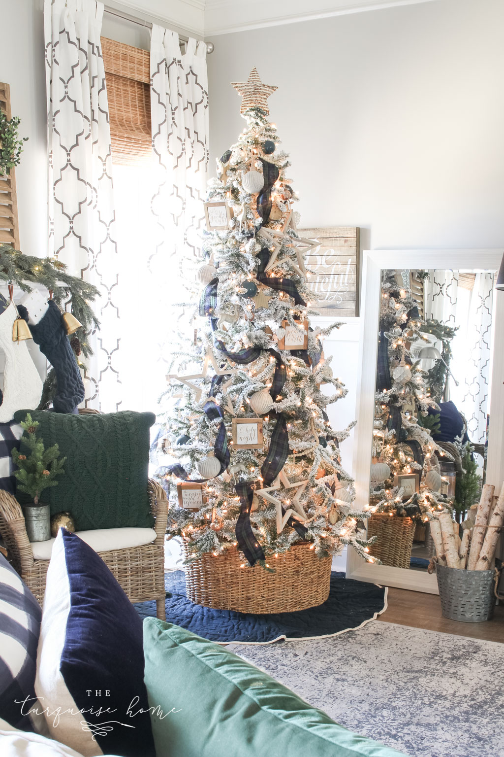 Gorgeous Flocked Christmas Tree with navy and green plaid ribbon and a basket tree collar. | Where to Find the BEST Artificial Christmas Trees 