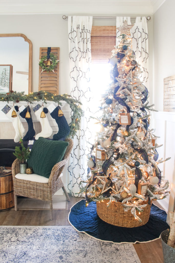 Pretty Christmas tree with flocking and neutral ornaments and navy and green decor!