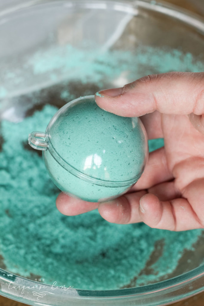 DIY Bath Bombs - add mixture to each side of the mold and then press them together